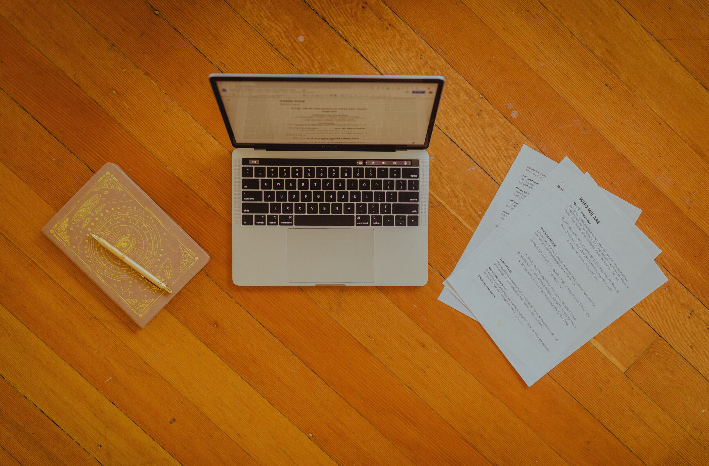 A conversion copywriter's laptop and notebook