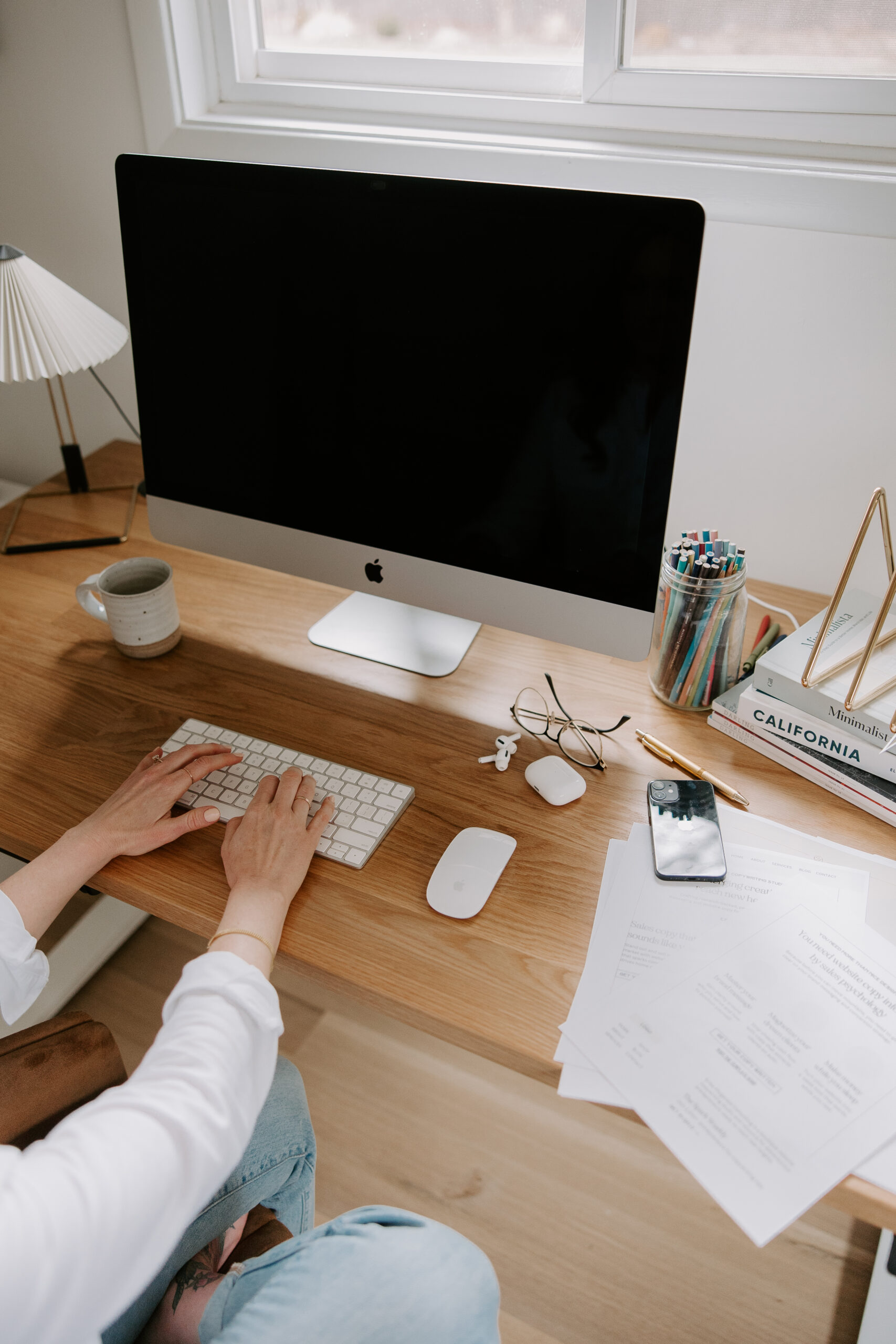 A website copywriter working on an iMac at a desk