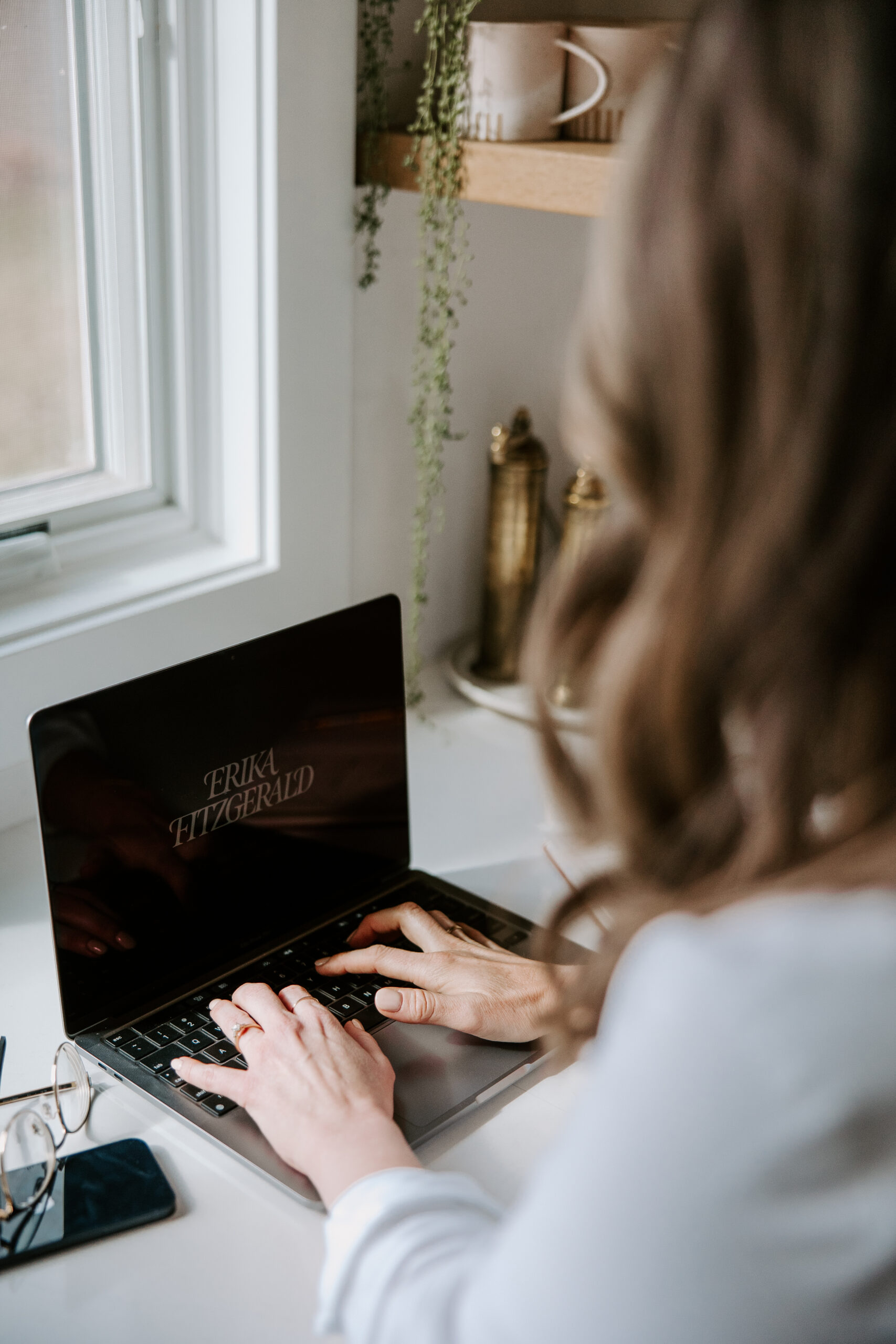 A conversion copywriter working on a laptop